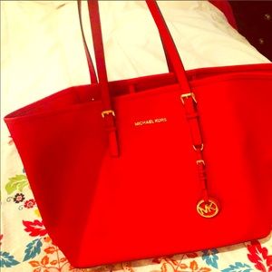 Michael Kors red carry all used 2 times.